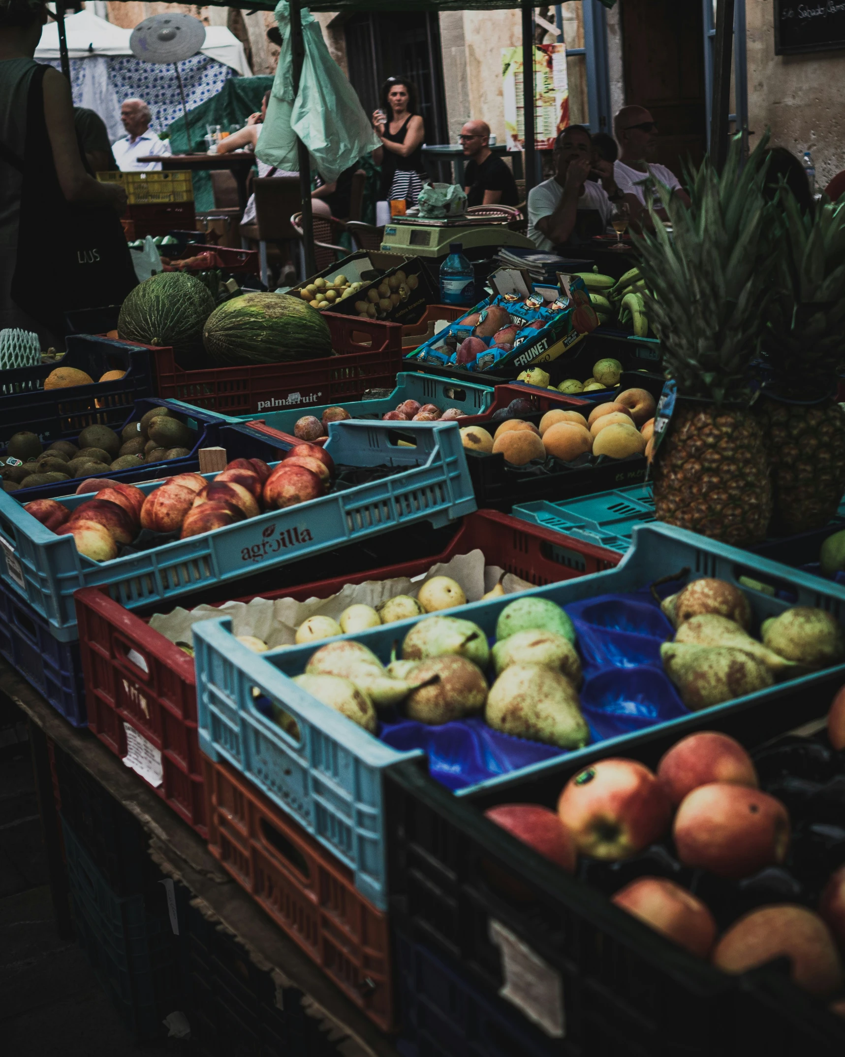 a bunch of fruit is sitting in crates at the market