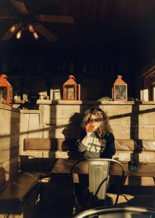 a woman sitting on top of a wooden bench