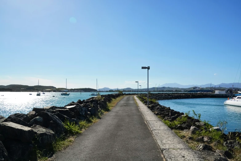 a bike path on the side of the water next to the shore