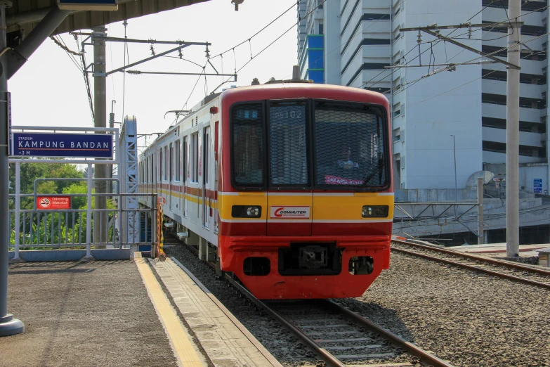 a train moving down the tracks in an open station