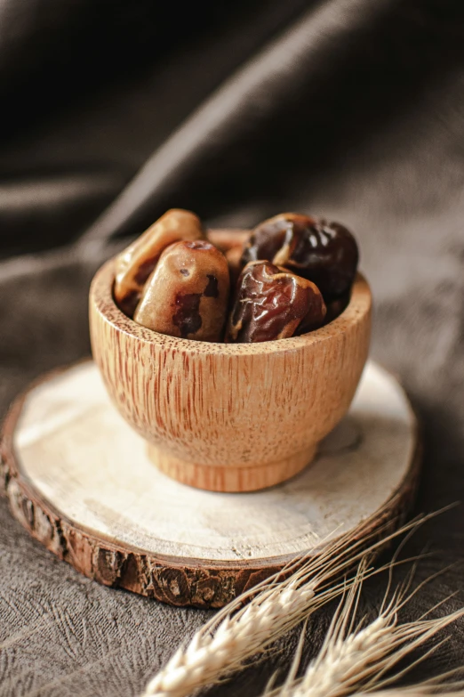 a small wooden bowl filled with nuts