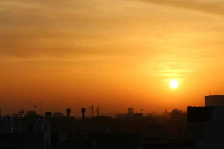 a red and yellow sunset with clouds in the sky