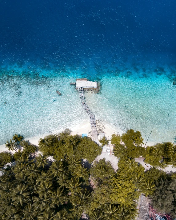 the view from above of some white boats docked in clear water