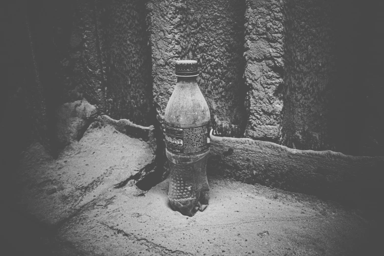 a bottle sitting on top of the cement