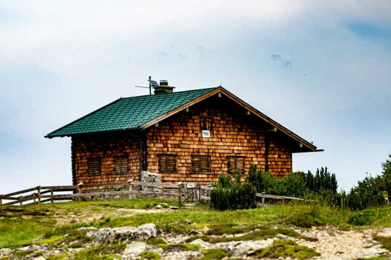 a small cabin on the top of a mountain