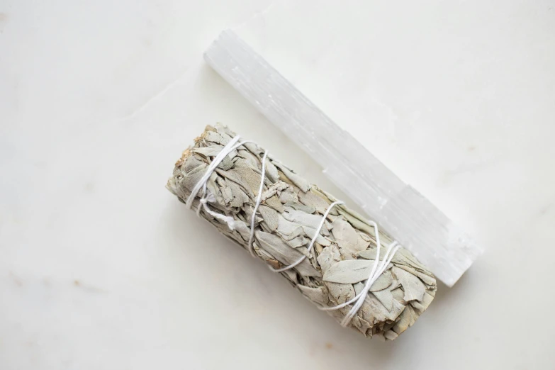 two small white sticks wrapped in paper on a white counter