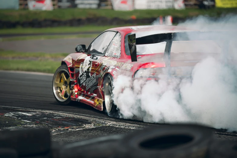 a drifting car on track with smoke coming from its exhaust