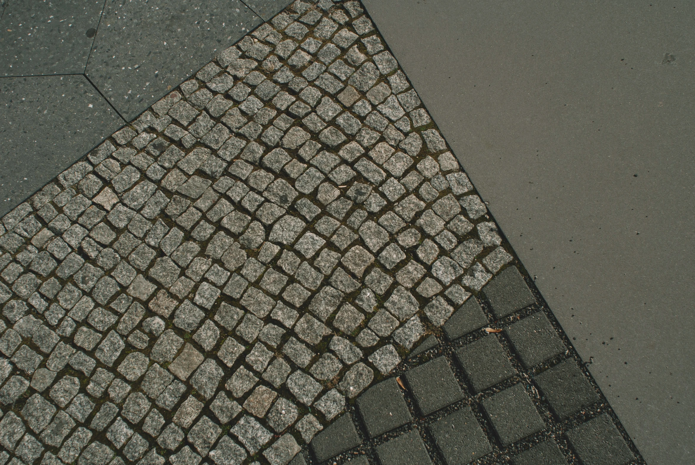 this is a black and white sidewalk and stop sign