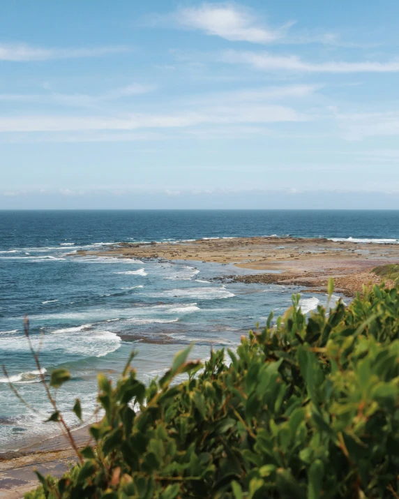 a body of water with waves coming up to the shore