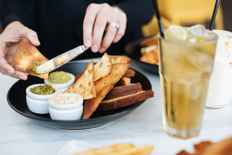 a person  into some food on a plate