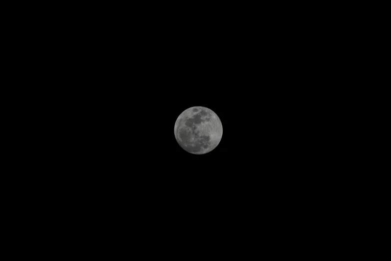 the moon is seen in the dark night sky