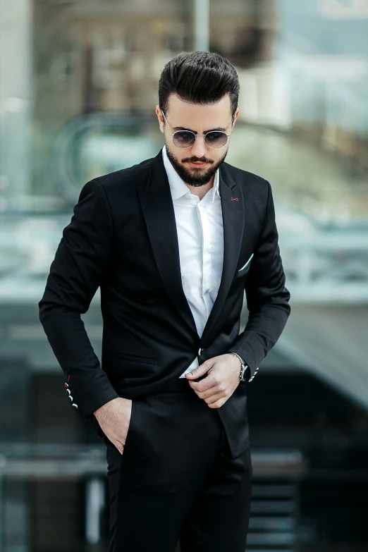 young man in a black suit and white shirt