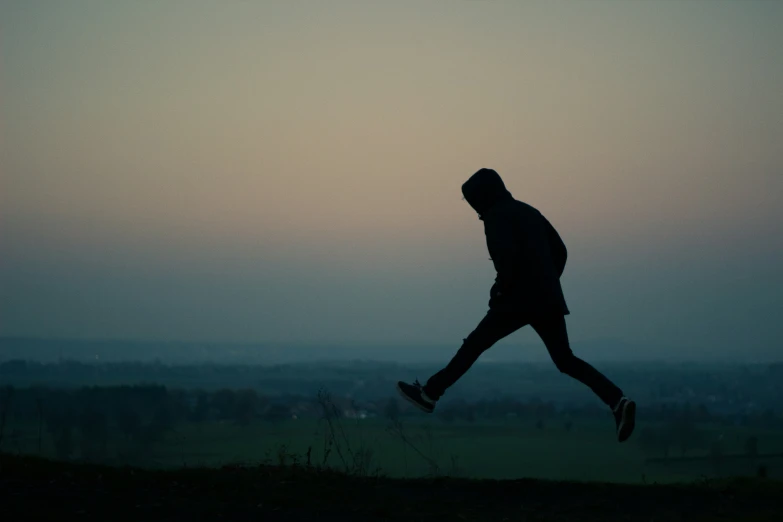 a man in silhouette running through the air