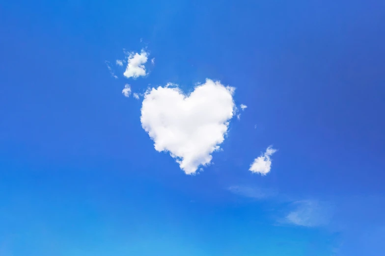 a lone heart shaped cloud on blue sky