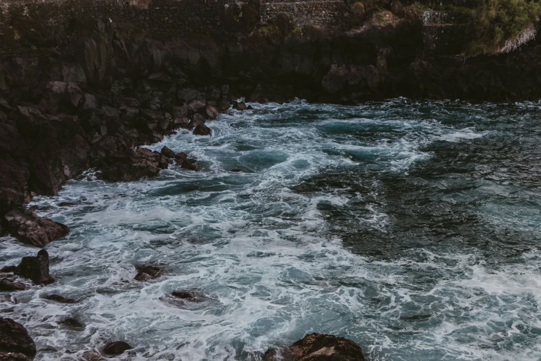 there is water that is rushing over the rocks