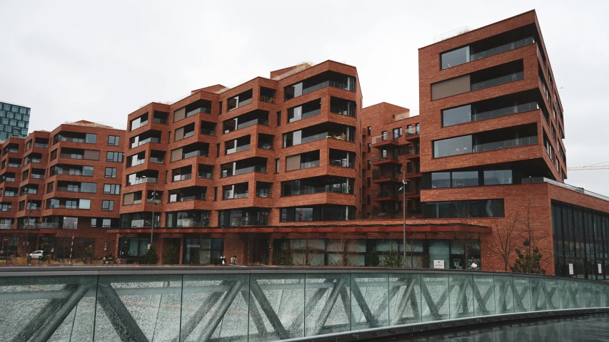 two red buildings side by side with a glass walkway next to them