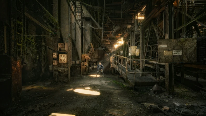 a man sitting on the ground in an old warehouse