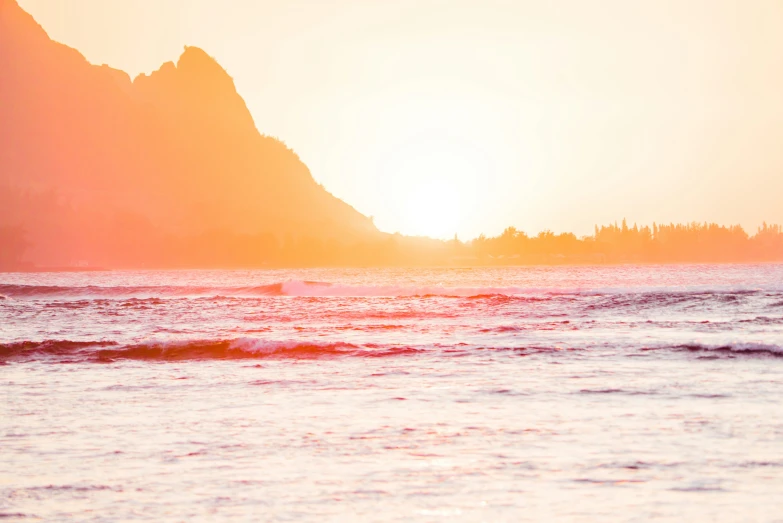 a large body of water with a mountain in the background