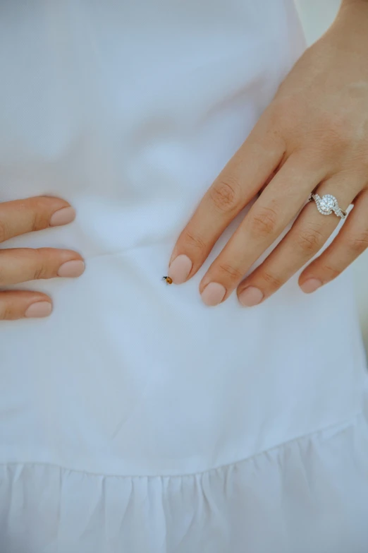 a woman's hands are shown with a diamond ring