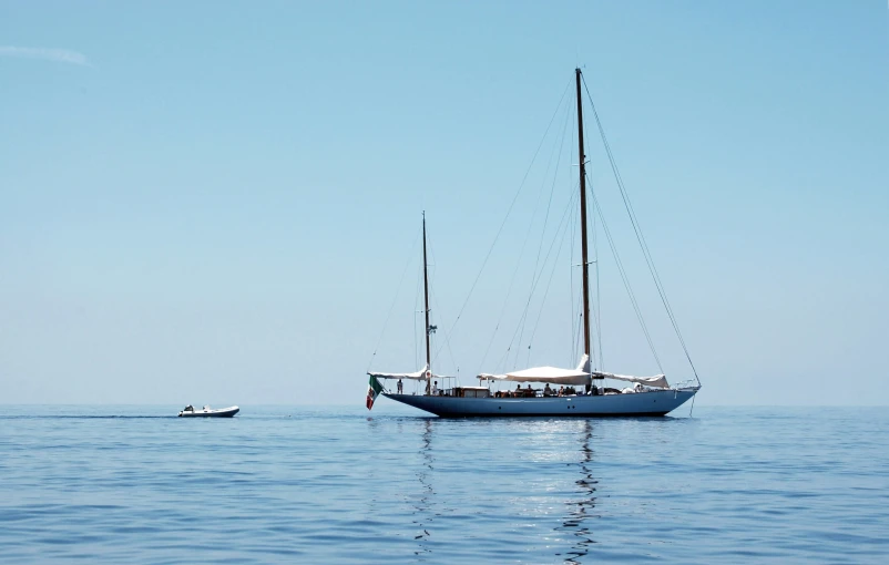 a sailboat is out on the ocean during the day