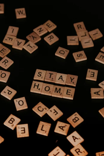 scrabble type letter tiles spelling out the words stay home