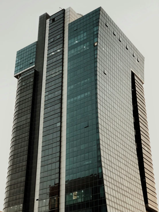 a tall glass and metal building with multiple windows