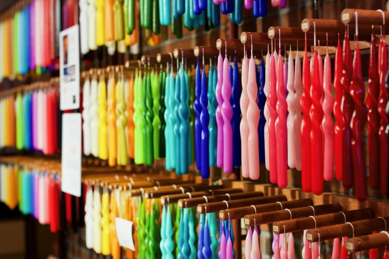 many colorful umbrellas hanging on a wall