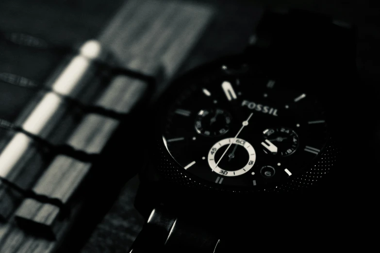 an image of black and white watch on top of plaid cloth