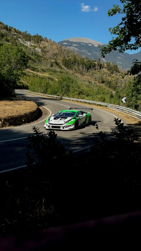 a sports car driving down the road during day