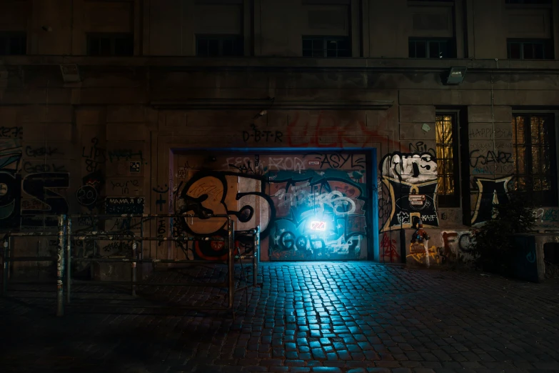 an open doorway with a bright light on it in the middle of the street