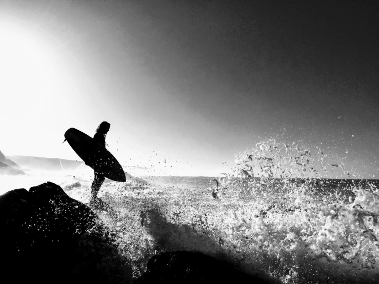 a surfer standing on a wave at the ocean