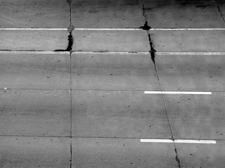 a plane that is flying over some pavement