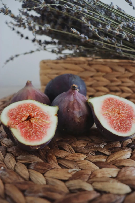 figs, a lavender bush, and a wicker basket are seen in this close up s