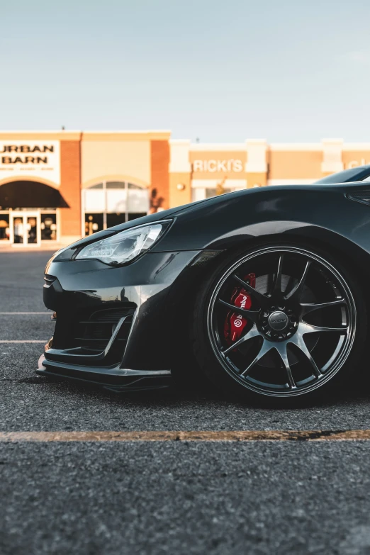 an expensive black sports car is parked outside