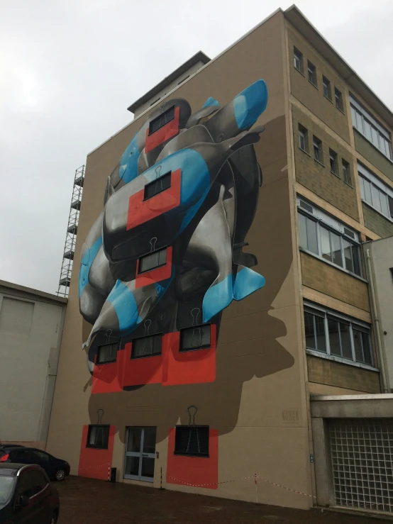 a giant building with a street art piece on the side