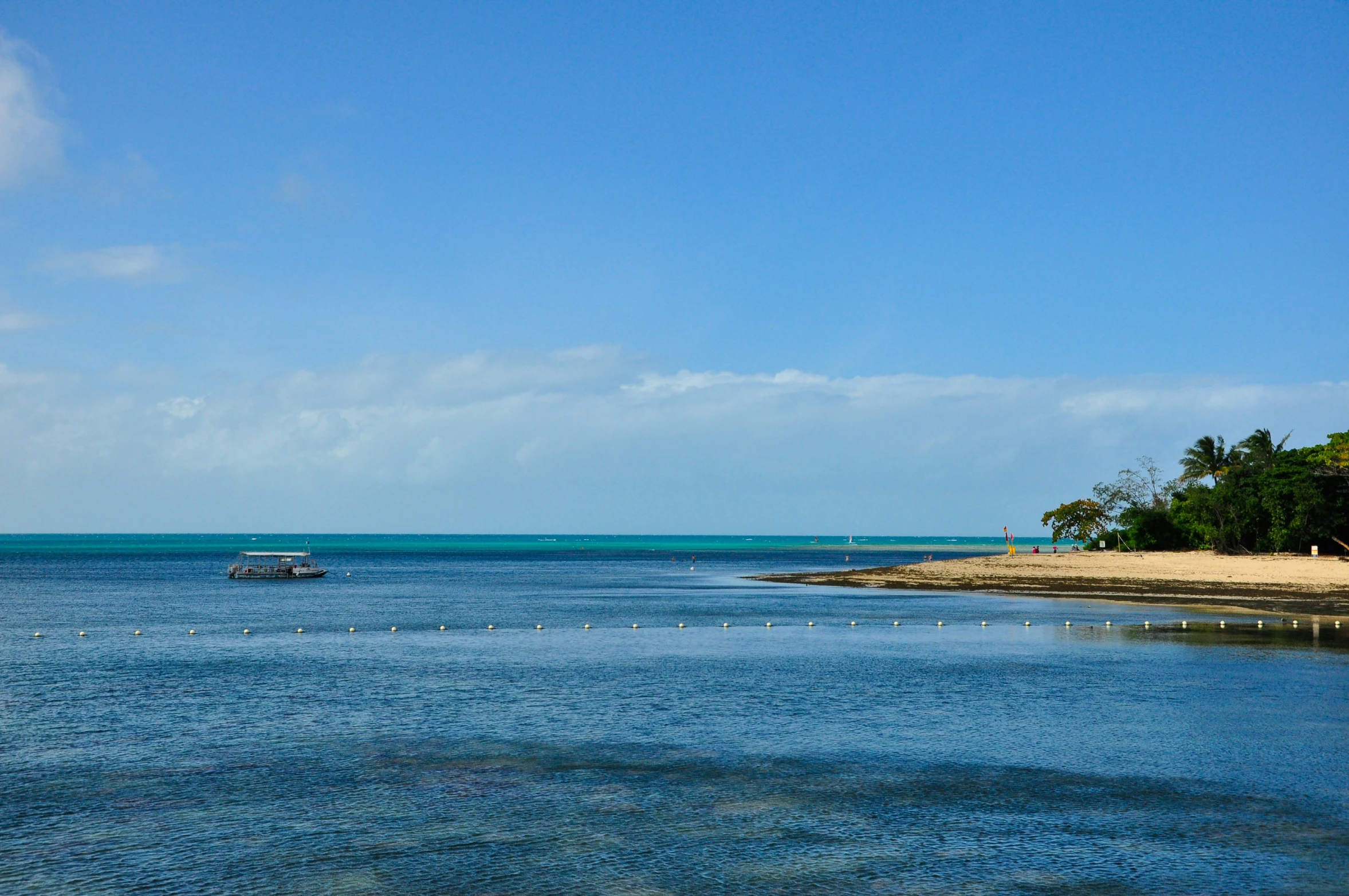 the beach is surrounded by some small boats