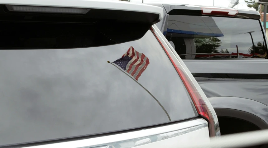 cars with their hoods open parked next to each other