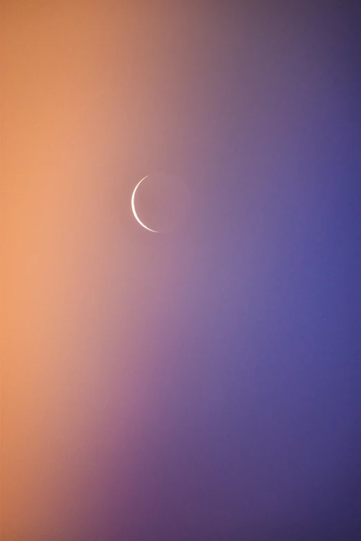 a crescent in the sky and half of an eclipse in the night sky