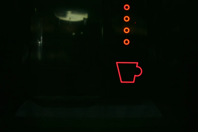there is a red cup on a black surface