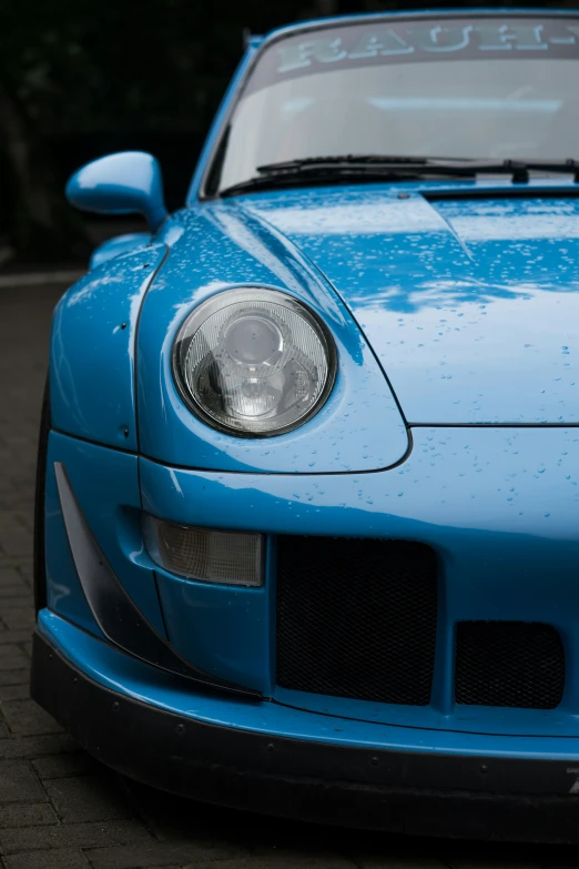 a blue sports car parked on a city street