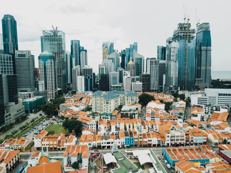 a view of a city from above of a roof that has a row of buildings along one side of it