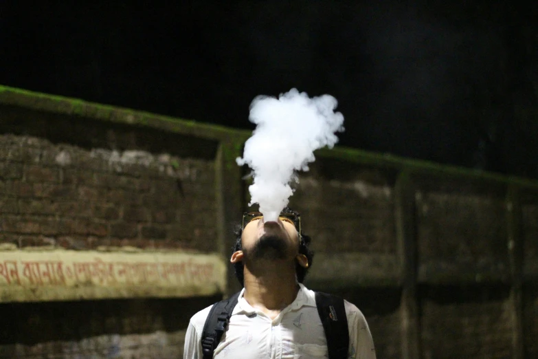 a man blowing steam out of his mouth