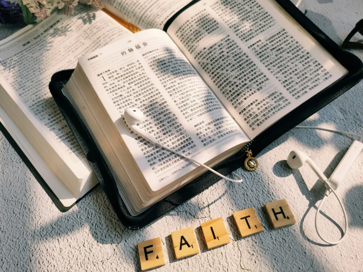 an open book on a carpet with the words faith spelled out