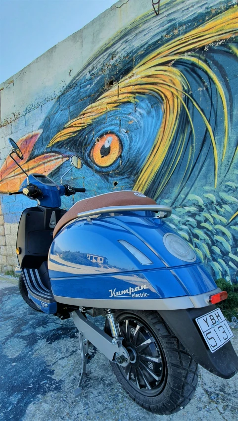 a motorcycle parked in front of a mural