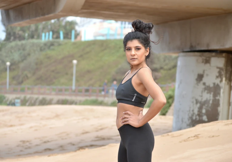 a woman poses for a po in her sports 