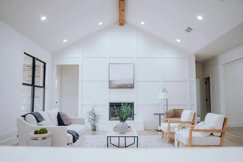 the living room of an upscale home is clean and white