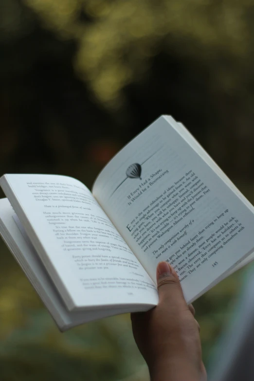 a person is holding open a book