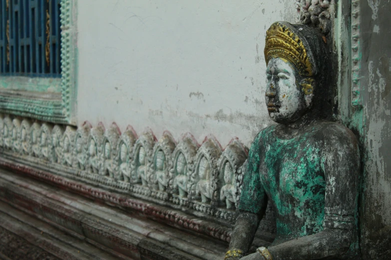 a statue of a buddhist man in a headdress