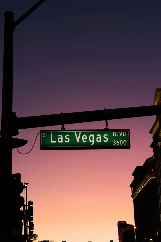 a street sign hanging off the side of a traffic light