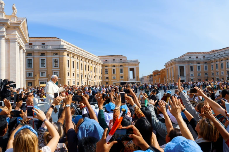 a man in a crowd with his hands up